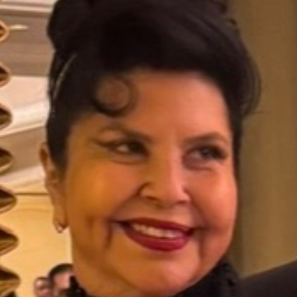 Smiling woman with dark hair and red lipstick